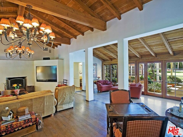 living room with an inviting chandelier, wood ceiling, and beamed ceiling