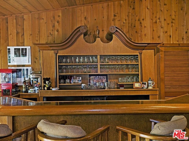 interior space featuring wooden walls, wooden ceiling, and vaulted ceiling