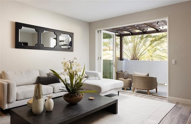 living room featuring wood finished floors and baseboards