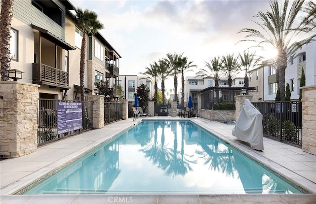 pool featuring a residential view and fence