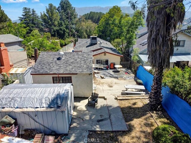 6843 Beckett St, Tujunga, CA 91042 - view of property exterior featuring a patio area, a mountain view, stucco siding, and a shingled roof
