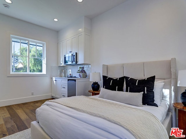 bedroom with dark hardwood / wood-style floors