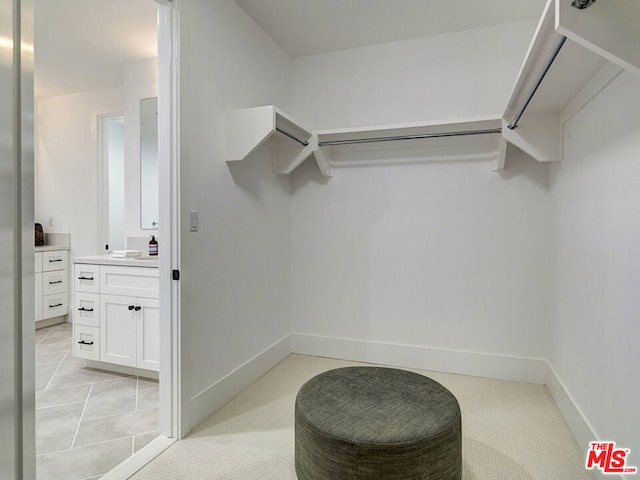 walk in closet featuring light tile flooring