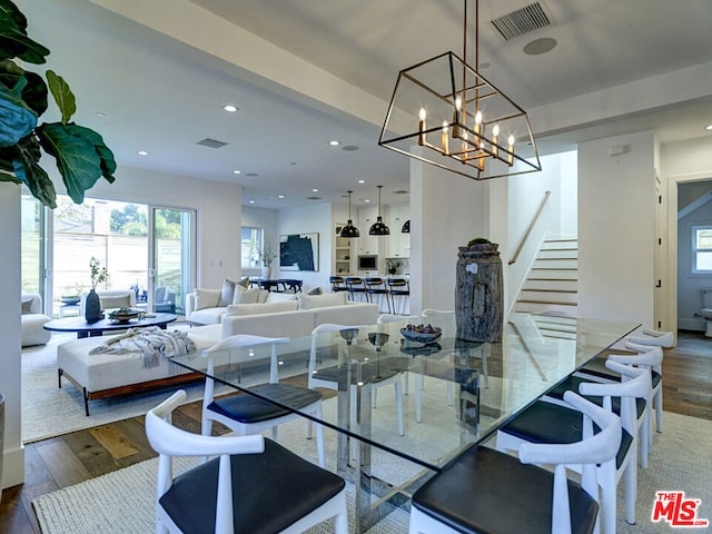 dining space featuring a notable chandelier and dark wood-type flooring