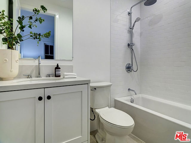 full bathroom featuring vanity, toilet, and tiled shower / bath