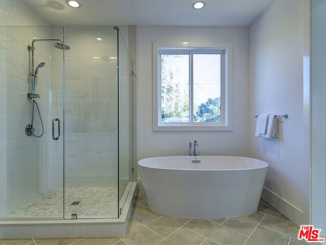 bathroom featuring tile flooring and independent shower and bath