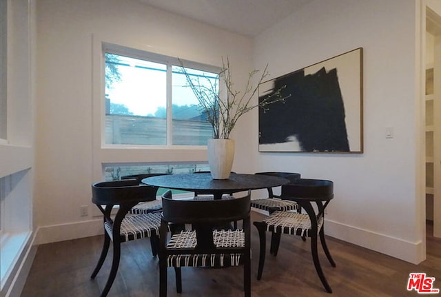 dining area with dark wood-type flooring