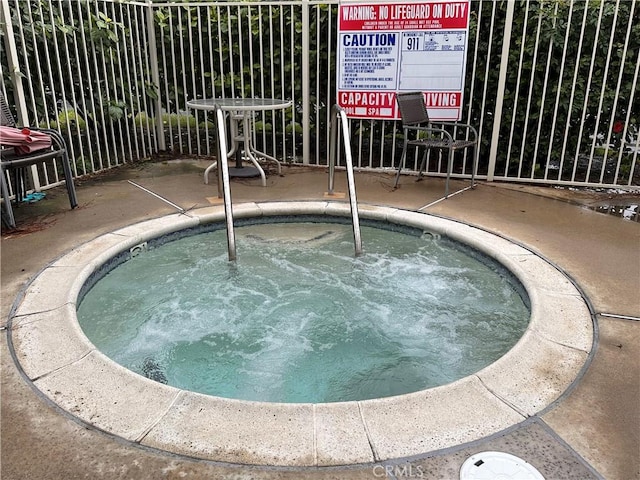 view of pool with a community hot tub