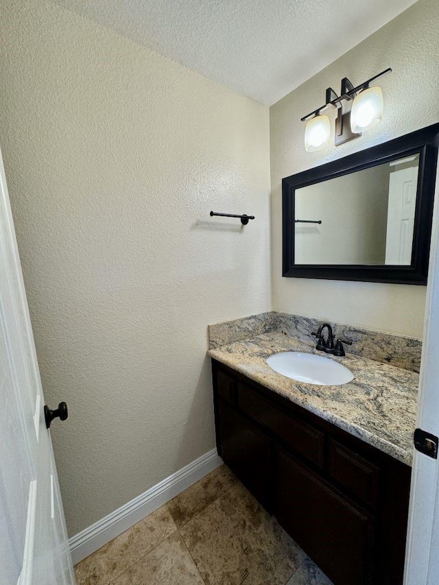 bathroom featuring vanity, tile patterned floors, and a textured ceiling