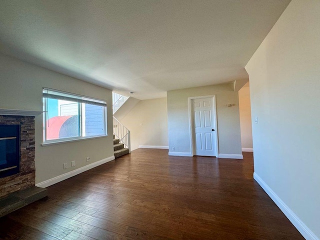 unfurnished living room featuring dark hardwood / wood-style floors and a fireplace