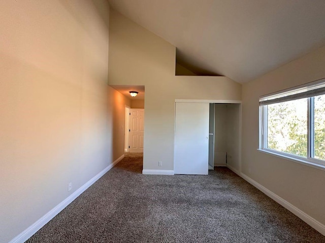 unfurnished bedroom with carpet floors, high vaulted ceiling, and a closet