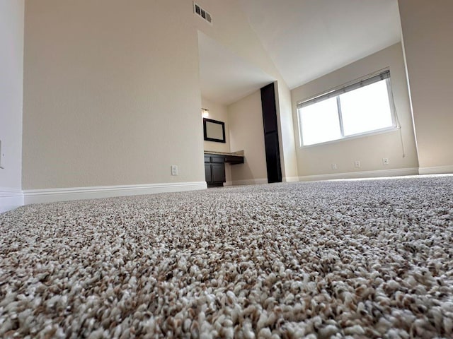 spare room featuring lofted ceiling