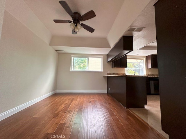 kitchen with ceiling fan, plenty of natural light, light wood-type flooring, and range hood