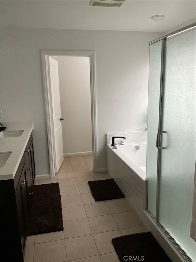 bathroom with tile flooring, plus walk in shower, and vanity