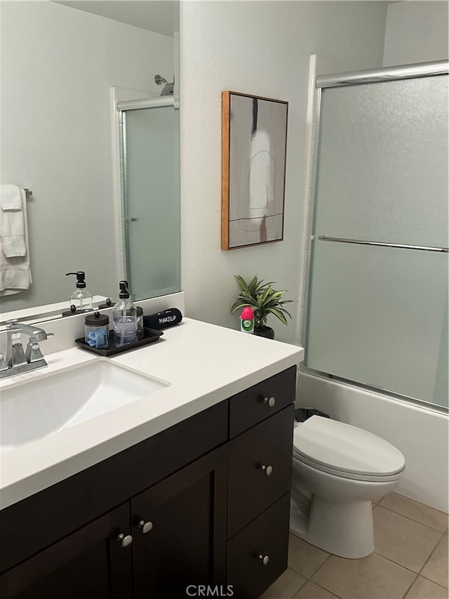 full bathroom with toilet, shower / bath combination with glass door, oversized vanity, and tile flooring