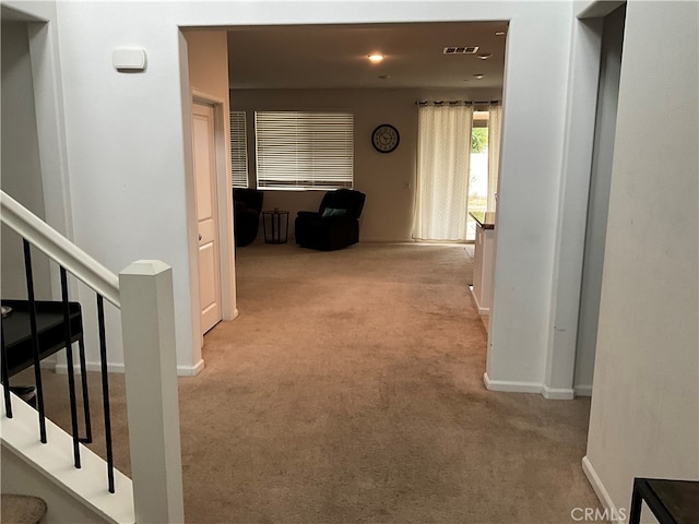 hall featuring light colored carpet