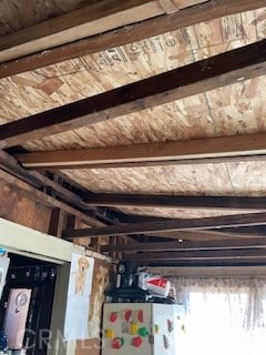 room details featuring fridge and beam ceiling