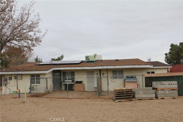 back of house with solar panels