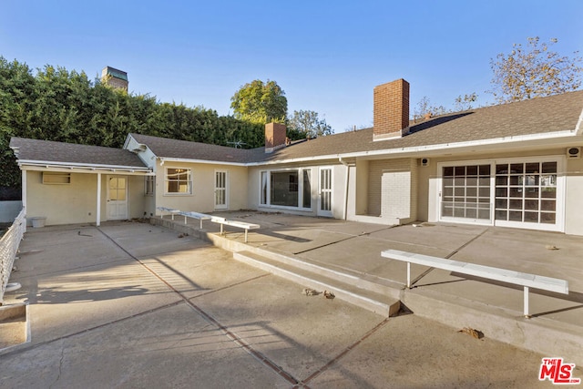 back of property featuring a patio area