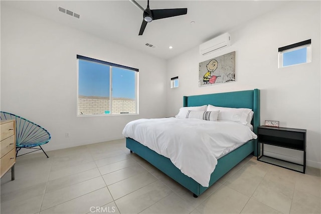 bedroom featuring ceiling fan, light tile patterned floors, and a wall unit AC