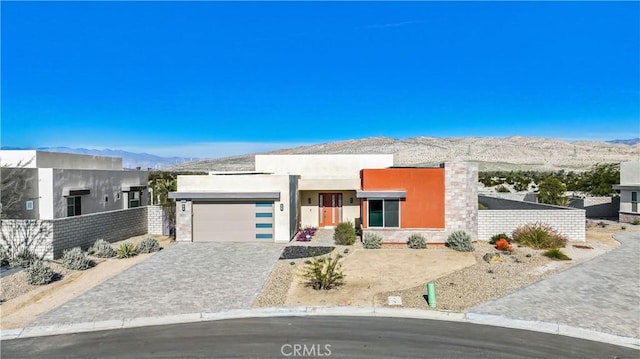 view of front of house featuring a garage and a mountain view