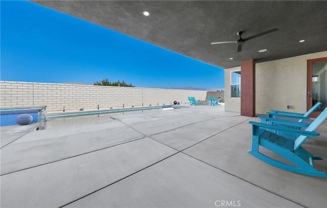 view of patio / terrace with an empty pool and ceiling fan