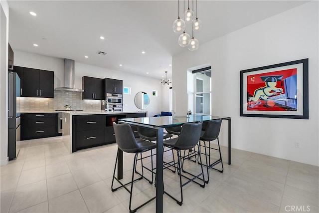 dining room with light tile patterned floors and an inviting chandelier