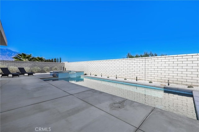 view of swimming pool with an in ground hot tub and a patio area