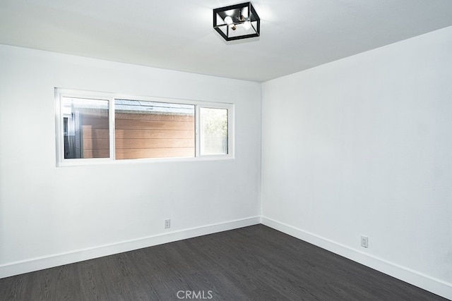 spare room with dark hardwood / wood-style flooring