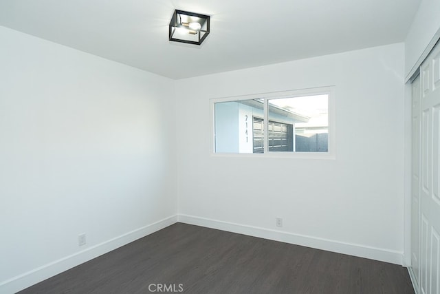 empty room with dark hardwood / wood-style floors