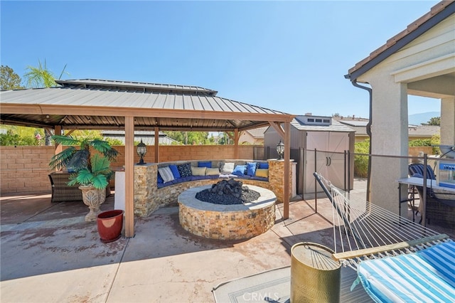 view of patio / terrace featuring a gazebo and a fire pit