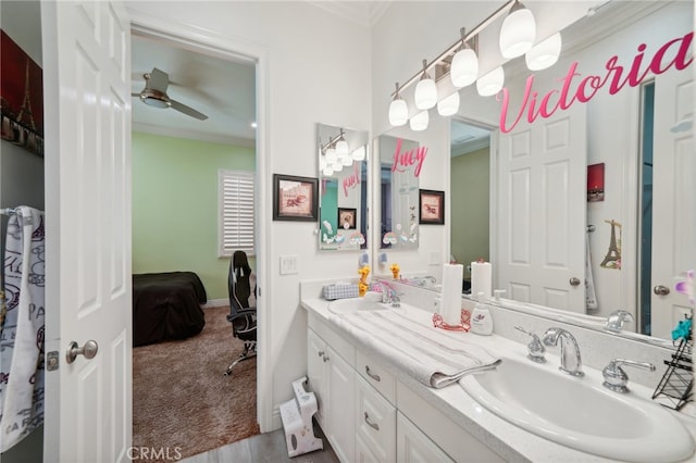 bathroom featuring ceiling fan, vanity, and crown molding