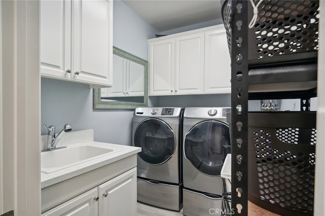 laundry area with cabinets, sink, and washing machine and dryer