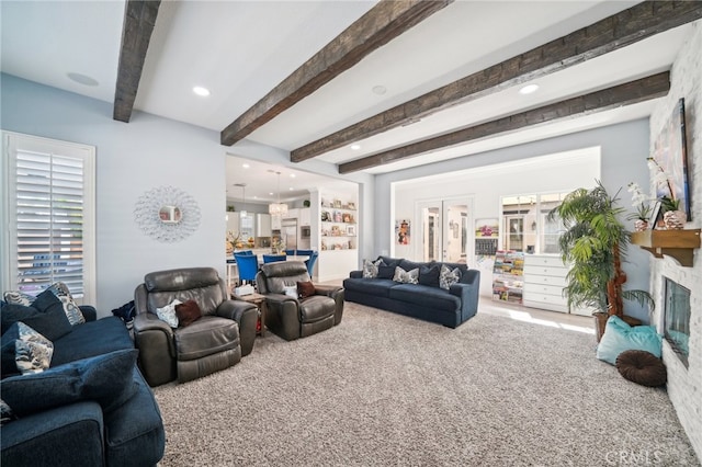 living room with beamed ceiling and carpet floors