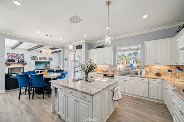 kitchen featuring pendant lighting, light hardwood / wood-style floors, and white cabinetry