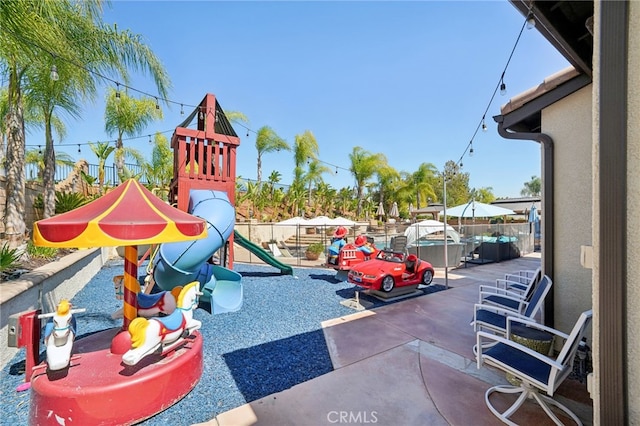 view of jungle gym with a hot tub