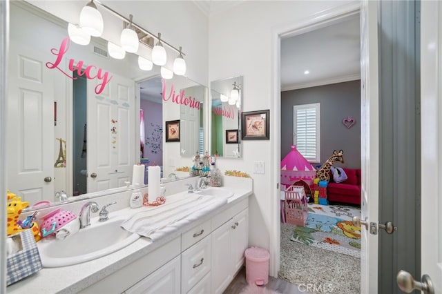 bathroom featuring ornamental molding, vanity, and wood-type flooring