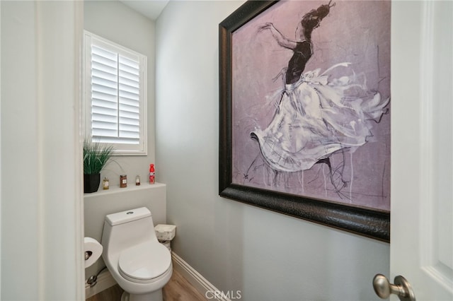 bathroom featuring wood-type flooring and toilet