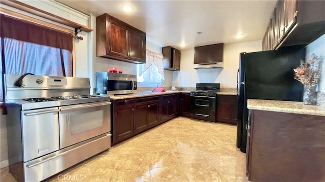 kitchen featuring dark brown cabinets, black appliances, wall chimney exhaust hood, light stone counters, and light tile floors