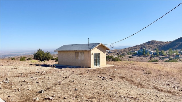 view of shed / structure featuring a mountain view and a rural view