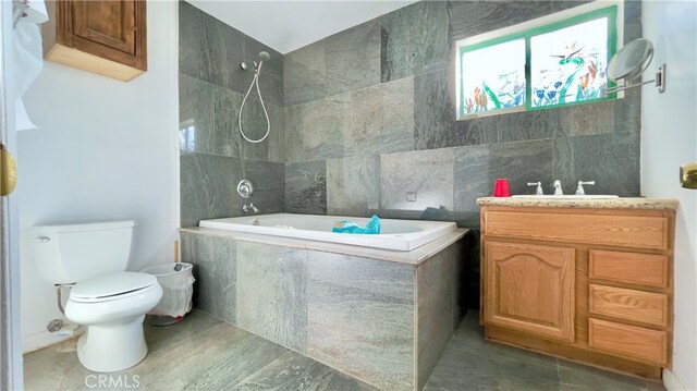 full bathroom featuring tile walls, toilet, tile flooring, tiled shower / bath combo, and vanity