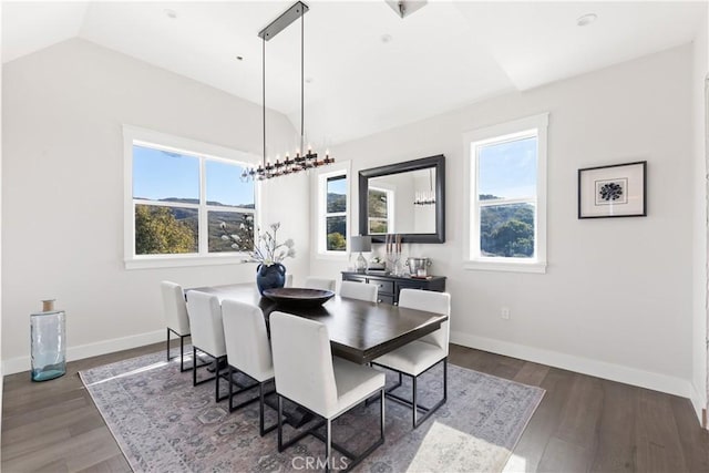 dining area featuring a chandelier, a wealth of natural light, dark wood-type flooring, and lofted ceiling