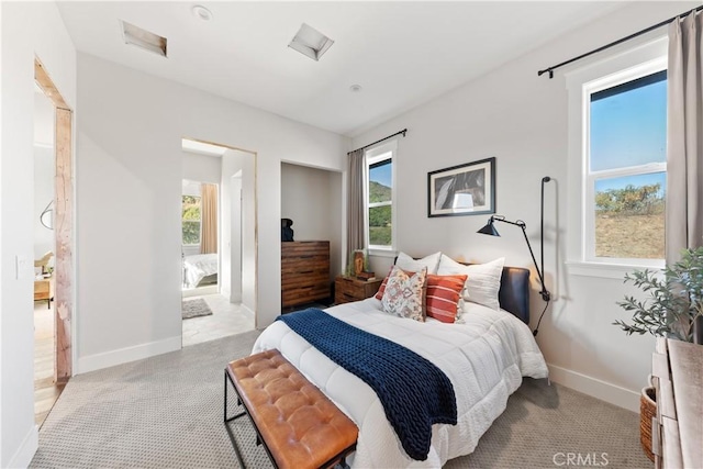 carpeted bedroom featuring multiple windows