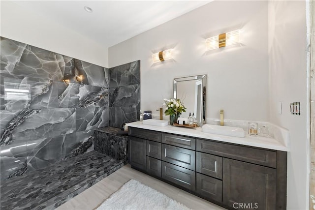 bathroom with walk in shower and vanity