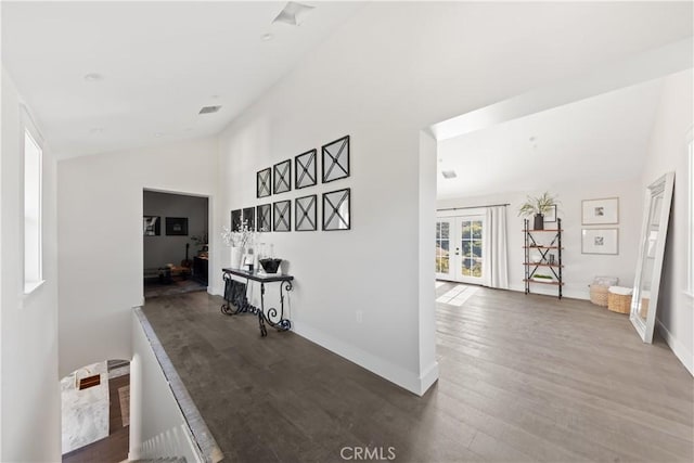 hallway featuring hardwood / wood-style floors, french doors, and vaulted ceiling