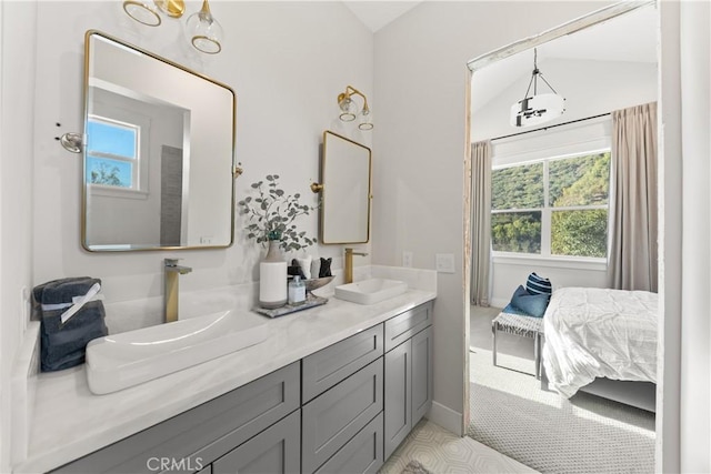 bathroom with vanity and lofted ceiling