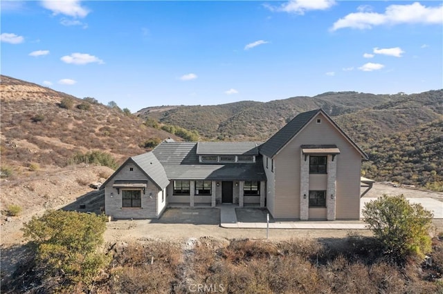 rear view of property with a patio area and a mountain view