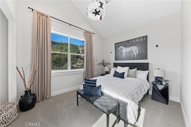 carpeted bedroom featuring vaulted ceiling