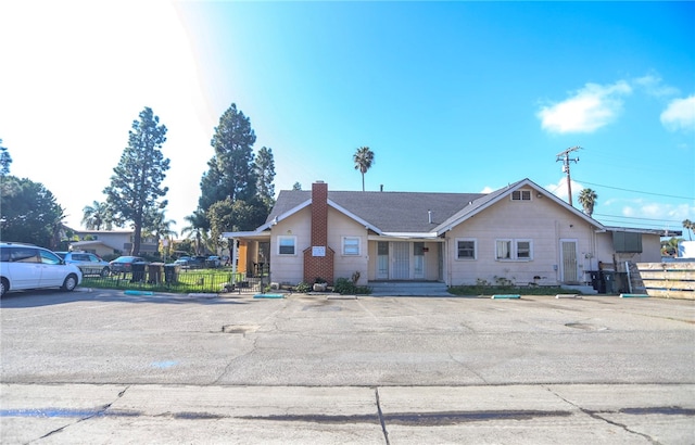 view of front of home featuring fence