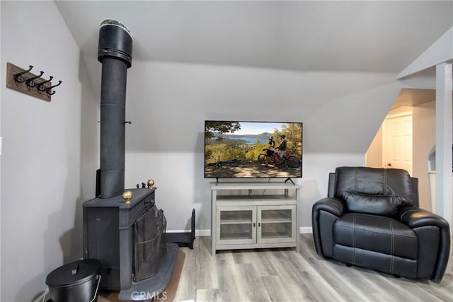 living area with vaulted ceiling and light hardwood / wood-style flooring